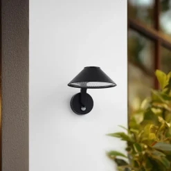 Lindby LED-væglampe Capelo, sort, metal, sensor, Ø20cm