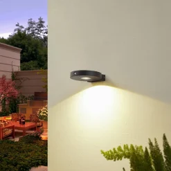 Lucande LED-solcelle-væglampe Tavon, rund, sort, sensor